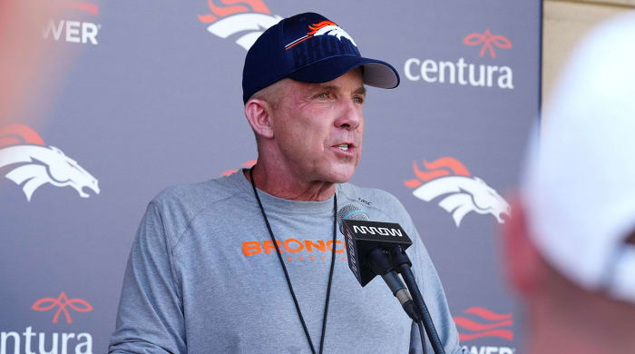 Broncos coach Sean Payton at a podium during training camp